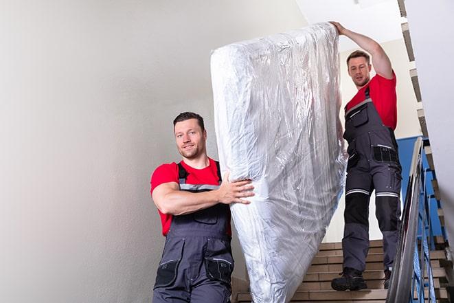 box spring being carried out of a house in Medina